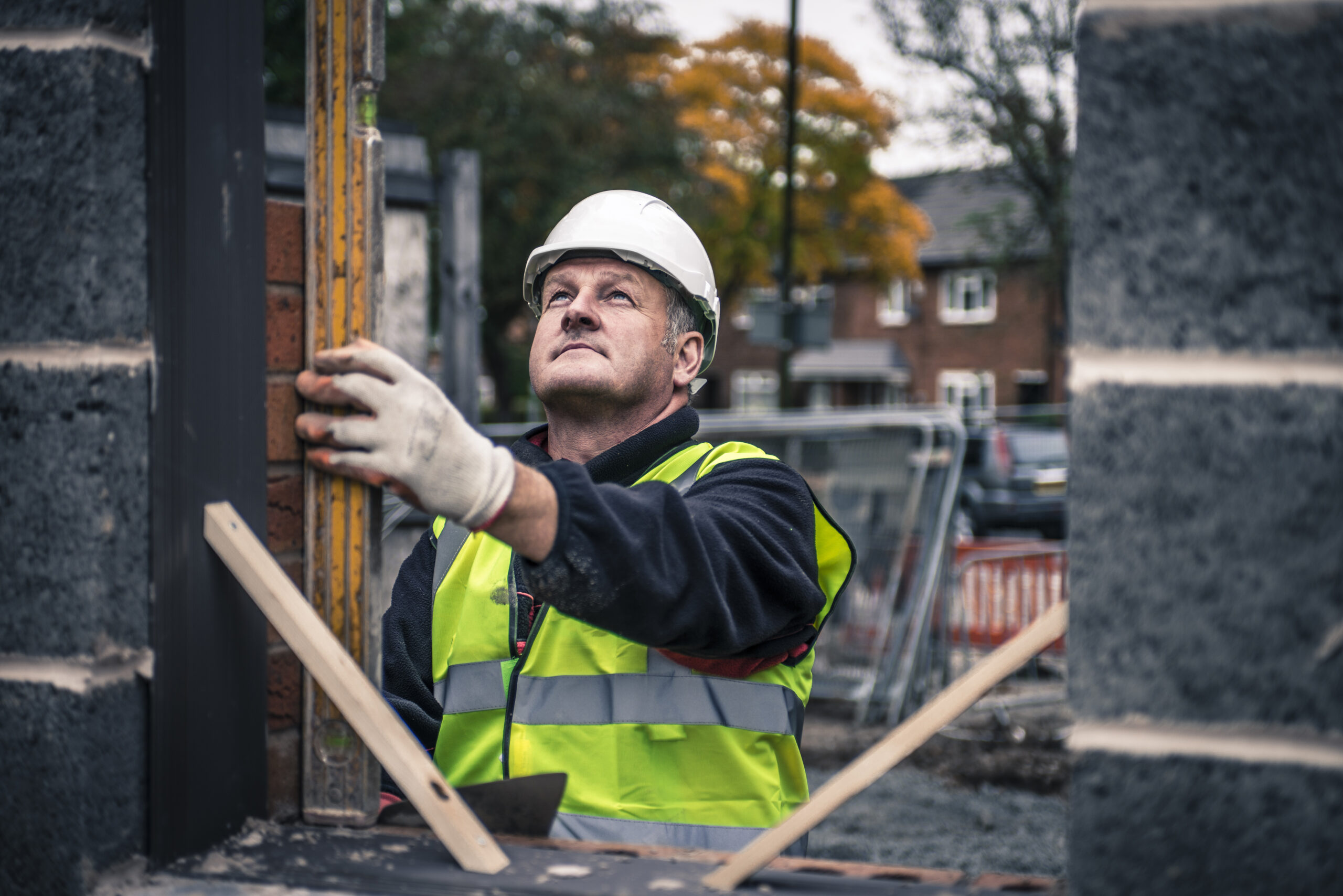 Workers laying bricks on construction site